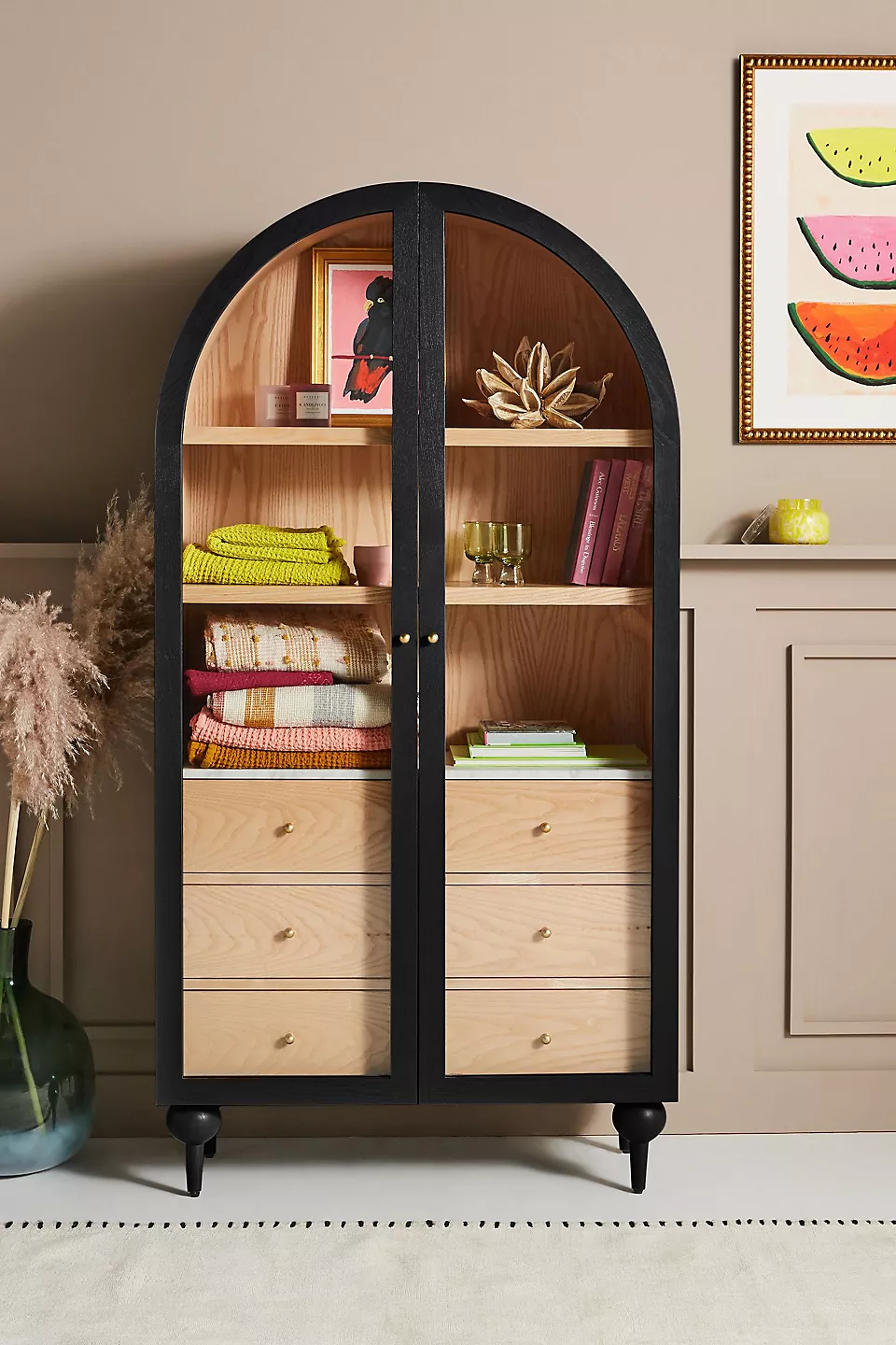 A wooden storage cabinet. An arched wood cabinet.