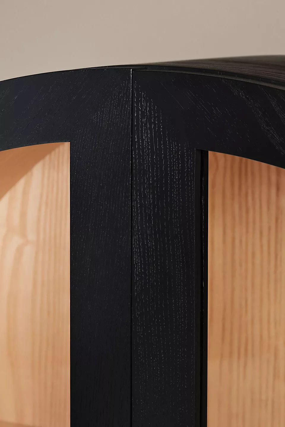 A wooden storage cabinet. An arched wood cabinet