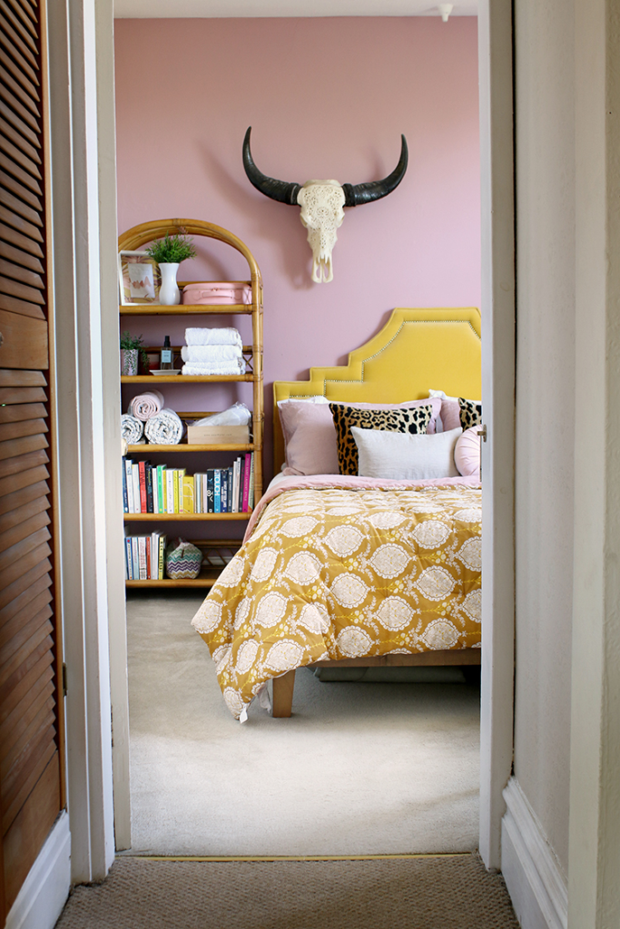Affordable guest bedroom with statement lamp and rug